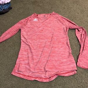 It’s a red Adidas shirt that is a small